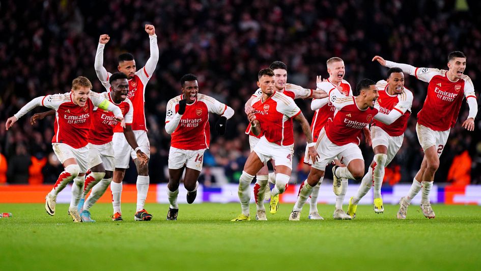 Arsenal players celebrate after winning the penalty shoot-out of the UEFA Champions League Round of 16, second leg match at the Emirates
