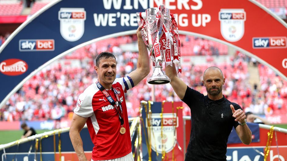 Paul Warne and Richard Wood lift the Sky Bet League One play-off trophy