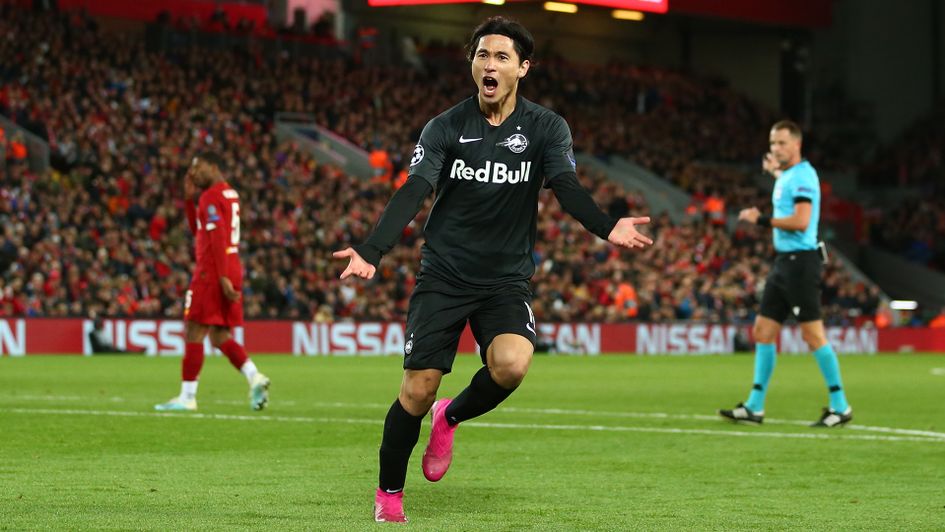 Takumi Minamino celebrates after scoring at Anfield