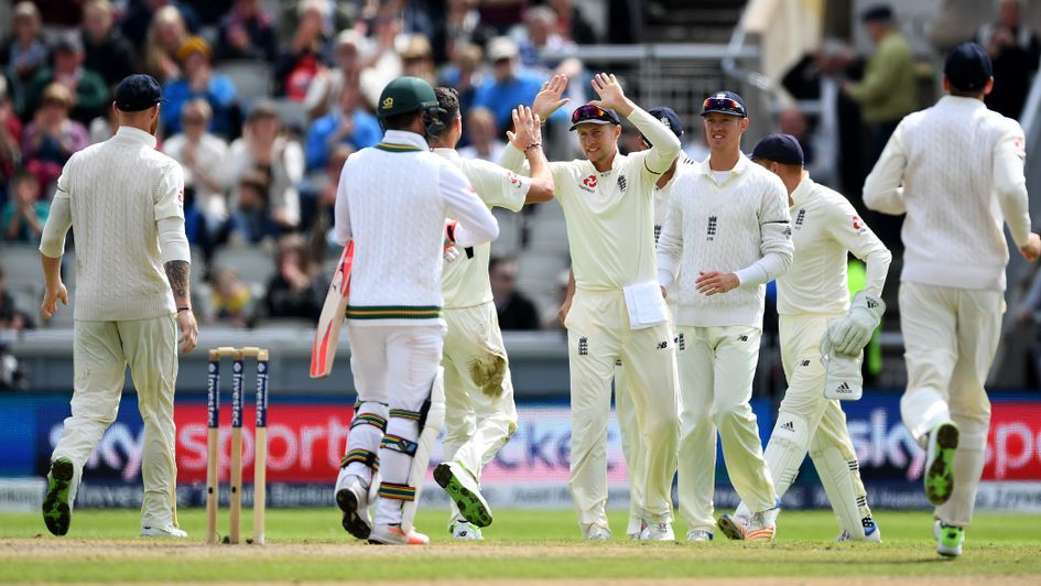 James Anderson and Joe Root celebrate the dismissal of Heino Kuhn