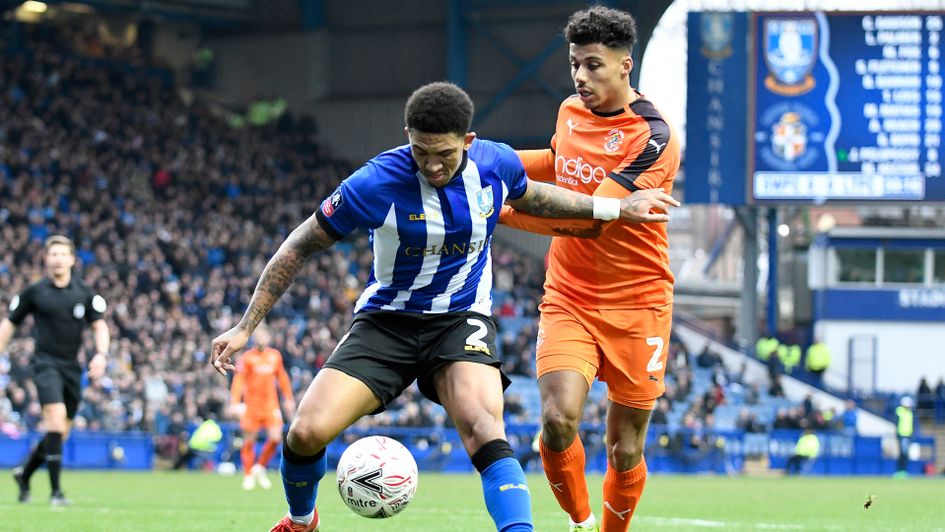 Liam Palmer (left) and James Justin battle for possession