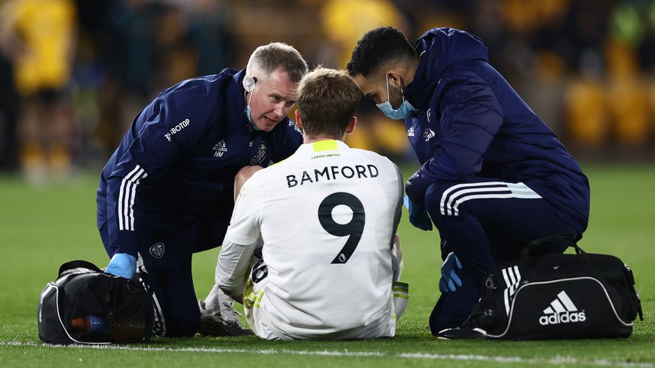 Leeds striker Patrick Bamford receives medical treatment at Wolves