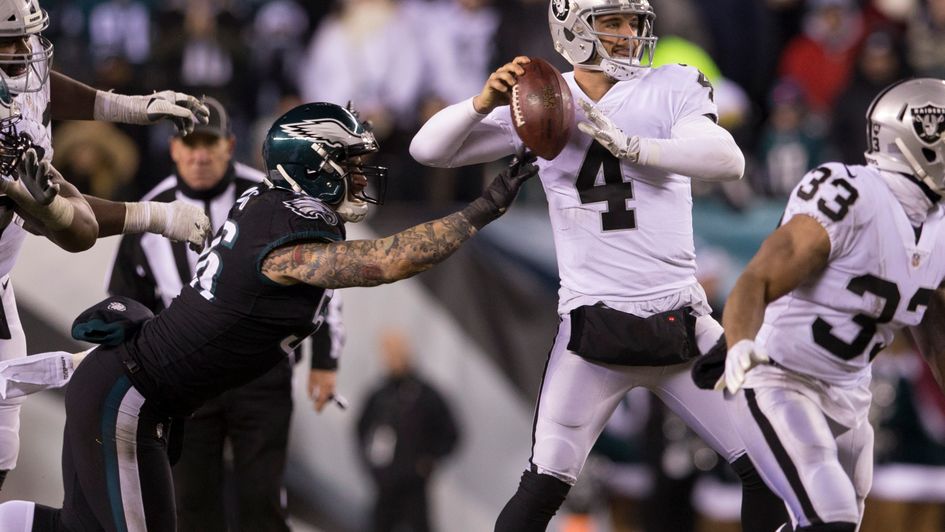 Chris Long of Philadelphia strips the ball from Derek Carr