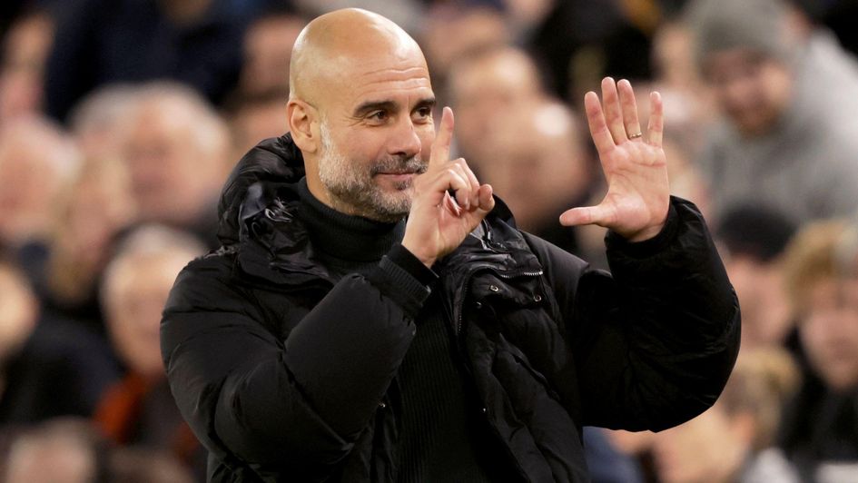 Pep Guardiola gestures to the crowd