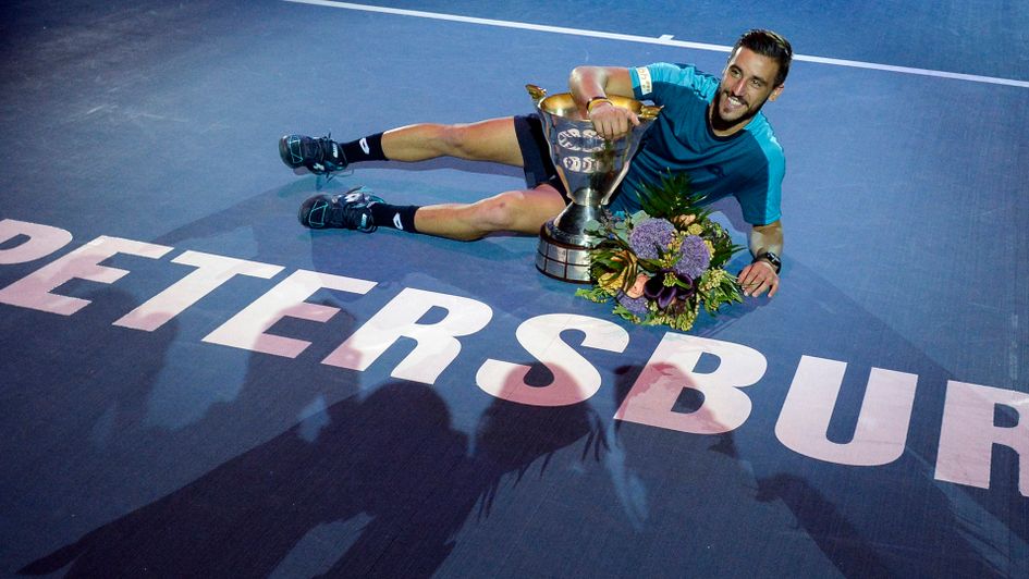 Damir Dzumhur celebrates with the trophy after winning the St. Petersburg Open 