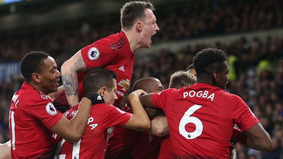 Manchester United players celebrate the opening goal at Cardiff