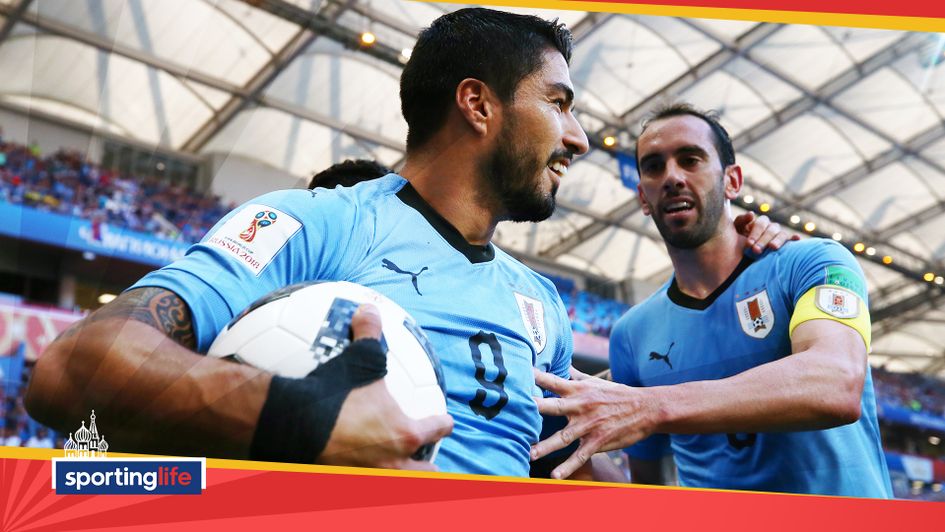 Luis Suarez celebrates scoring Uruguay's first goal against Saudi Arabia