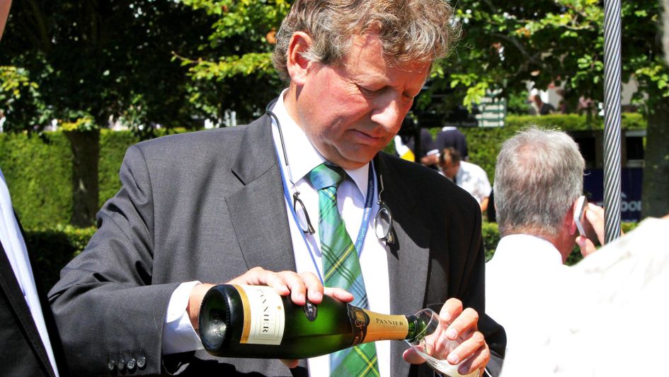 Mark Johnston celebrates with a glass of champagne - courtesy of Great British Racing