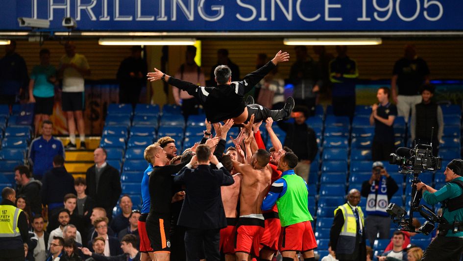 Huddersfield players lift David Wagner after Huddersfield secured a point against Chelsea