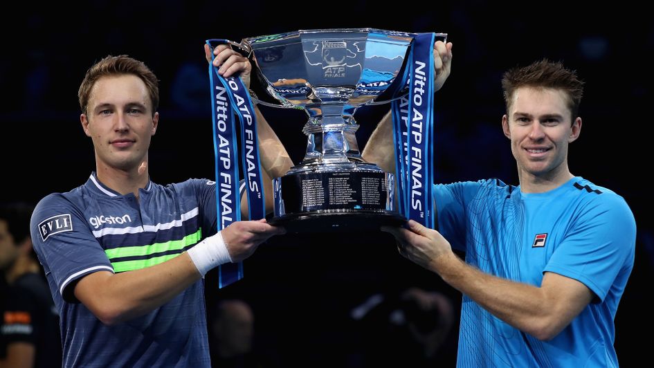 Henri Kontinen (l) and John Peers lift the trophy for the second year in a row