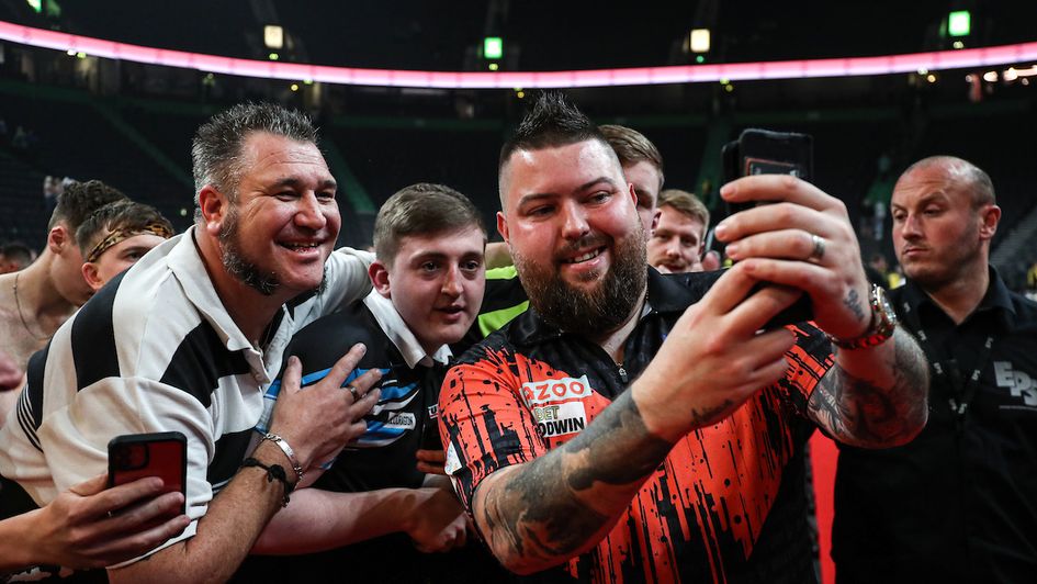 Michael Smith celebrates with fans (Kieran Cleeves/PDC)