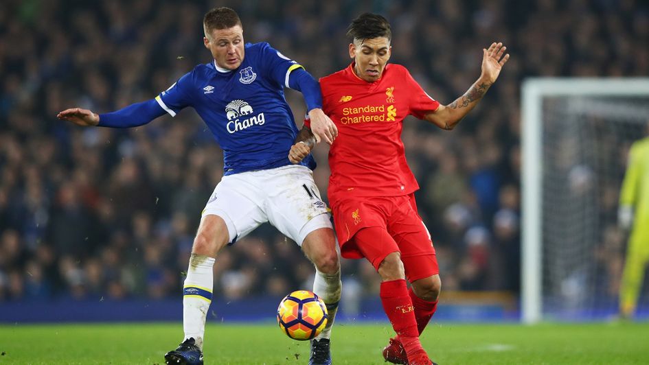 James McCarthy (left) battles against Roberto Firmino