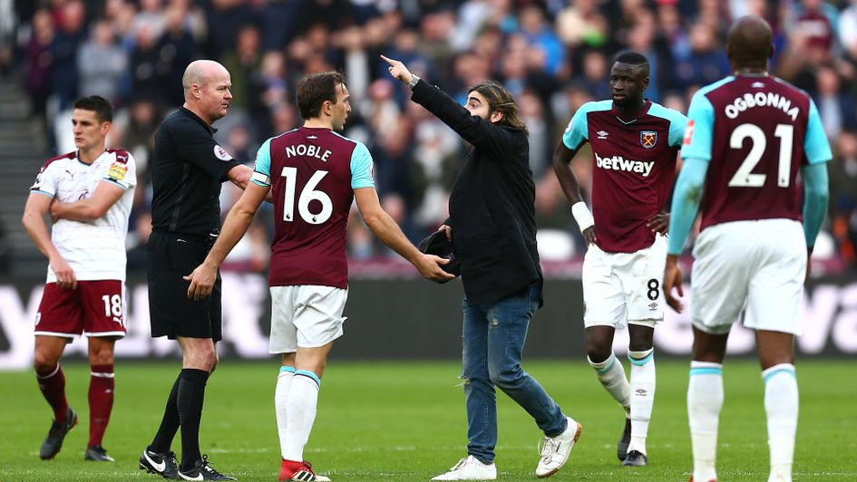 A pitch invader makes his feelings known at West Ham