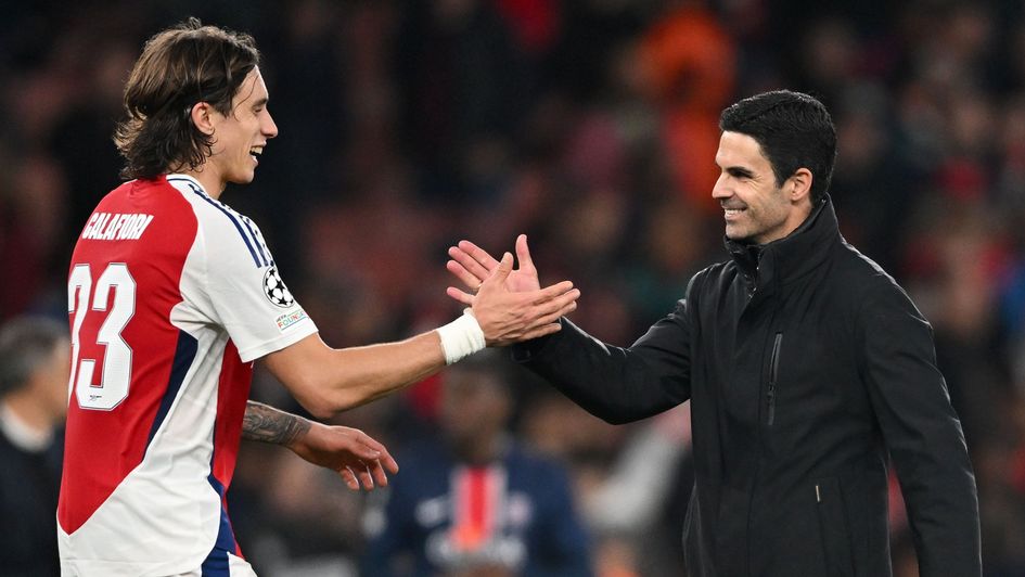 Arsenal manager Mikel Arteta shakes hands with Riccardo Calafiori