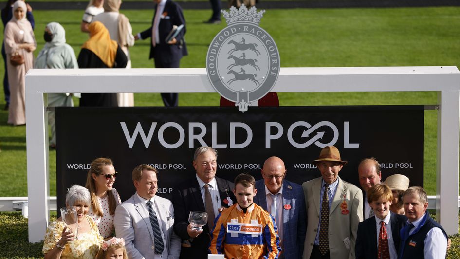 Jockey Dylan Hogan collects his prize after a winning ride at Goodwood