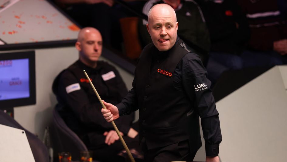 John Higgins eased into the second round