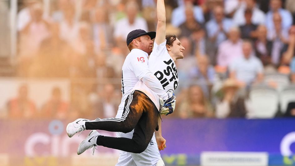 Jonny Bairstow carries a protester off the pitch