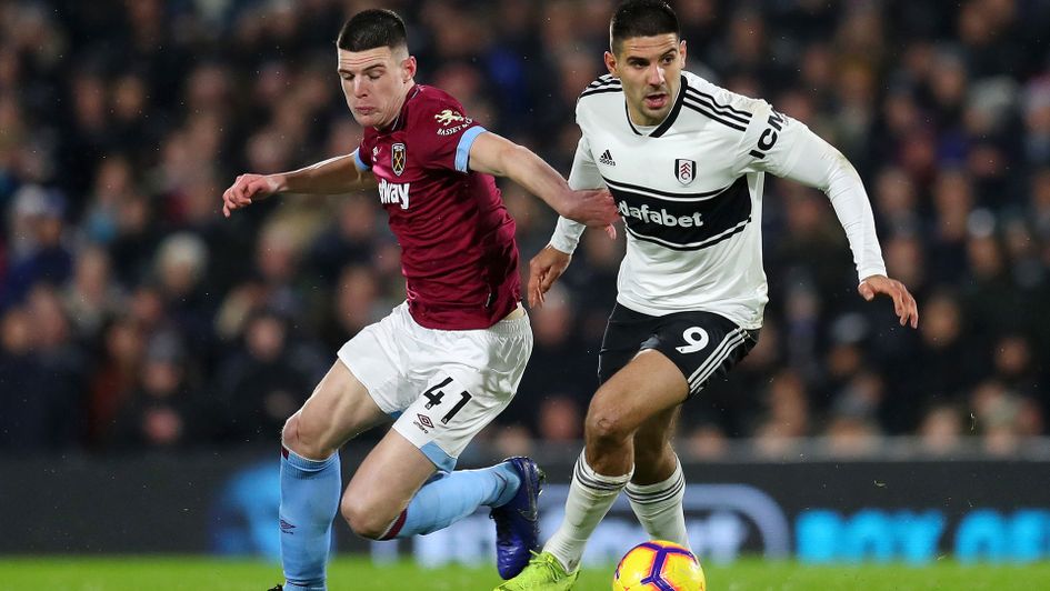 Aleksandar Mitrovic of Fulham is challenged by Declan Rice of West Ham United