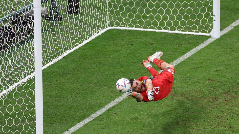 Emiliano Martinez saves a penalty in the shoot-out against the Netherlands