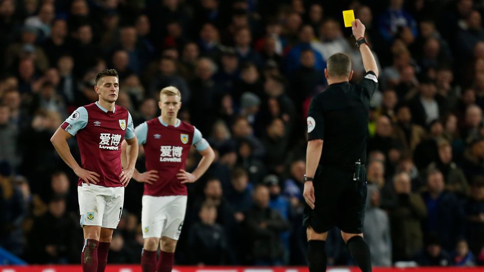 Ashley Westwood receives a yellow card