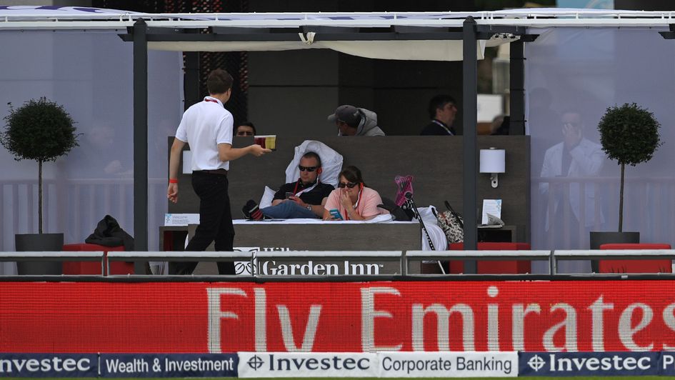 Spectators watch from a bed at Old Trafford