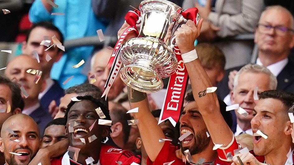 Manchester United's Bruno Fernandes lifts the FA Cup trophy