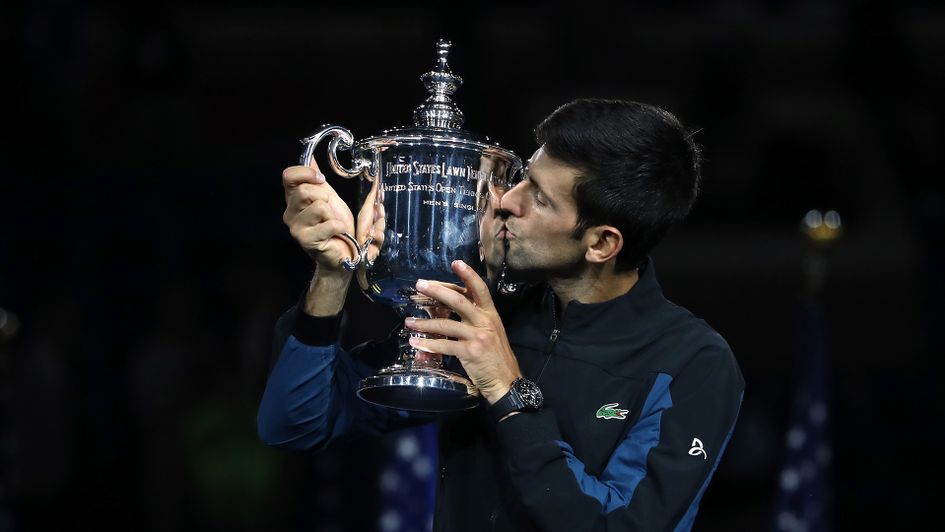 Novak Djokovic kisses the US Open trophy