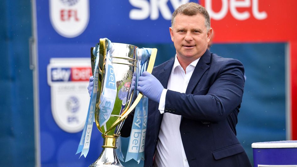 Mark Robins with the Sky Bet League One trophy