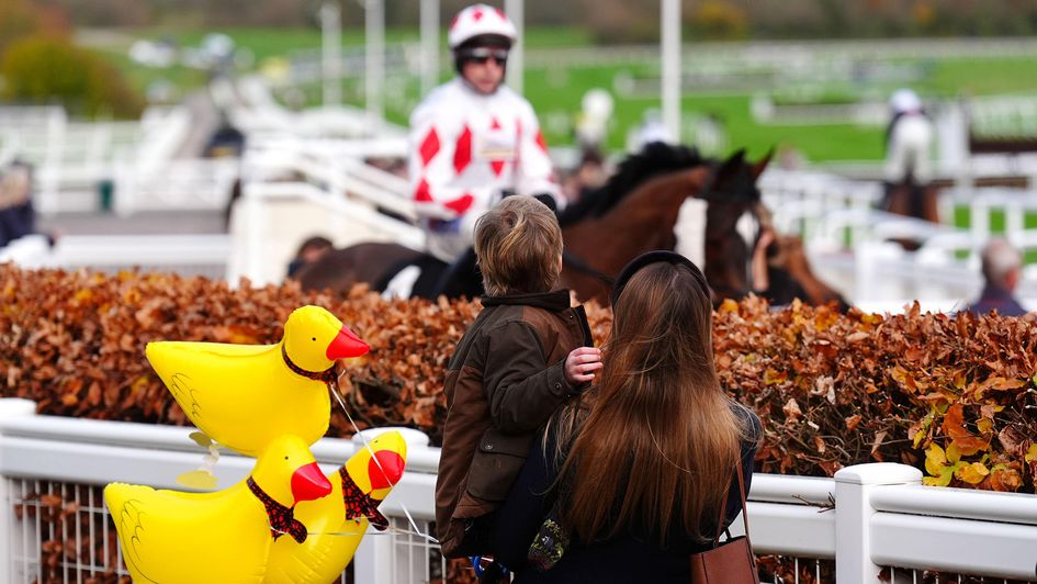 A young racegoer with balloons during November Sunday at Cheltenham