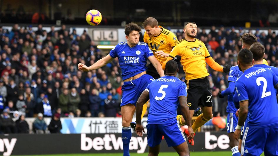 Wolves' Ryan Bennett gets above Leicester's Harry Maguire to head home
