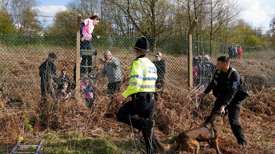 Protestors attempt to climb a fence at Aintree