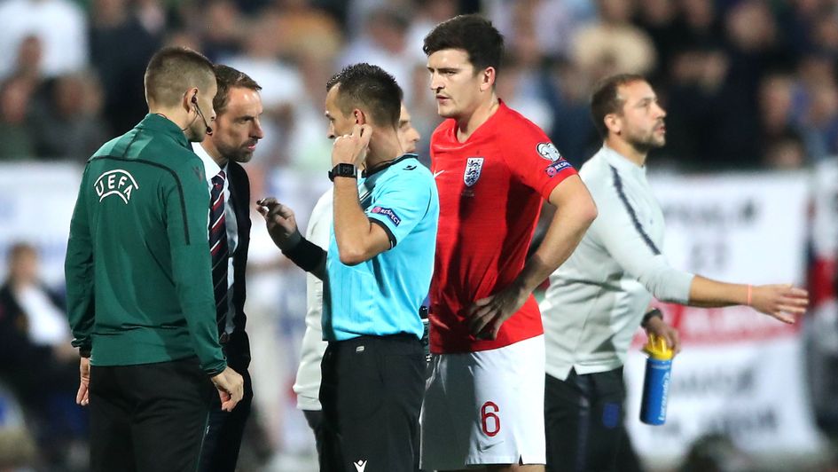 Gareth Southgate in conversation with officials