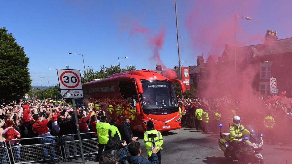 Liverpool fans welcome their team bus to Anfield ahead of their Premier League showdown with Wolves