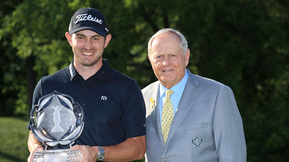 Patrick Cantlay is presented with the trophy by Jack Nicklaus