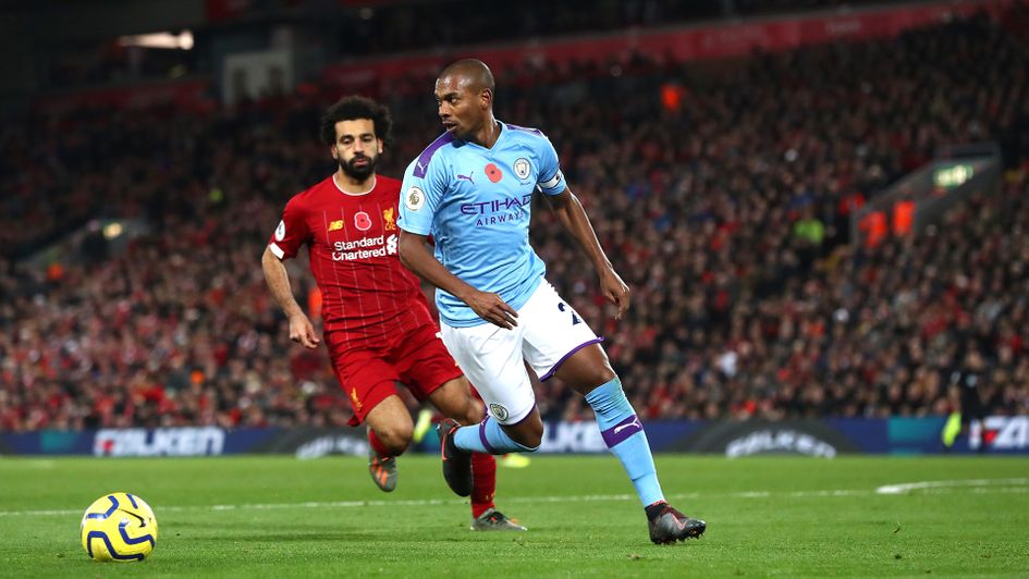 Fernandinho (right) and Mohamed Salah battle for the ball