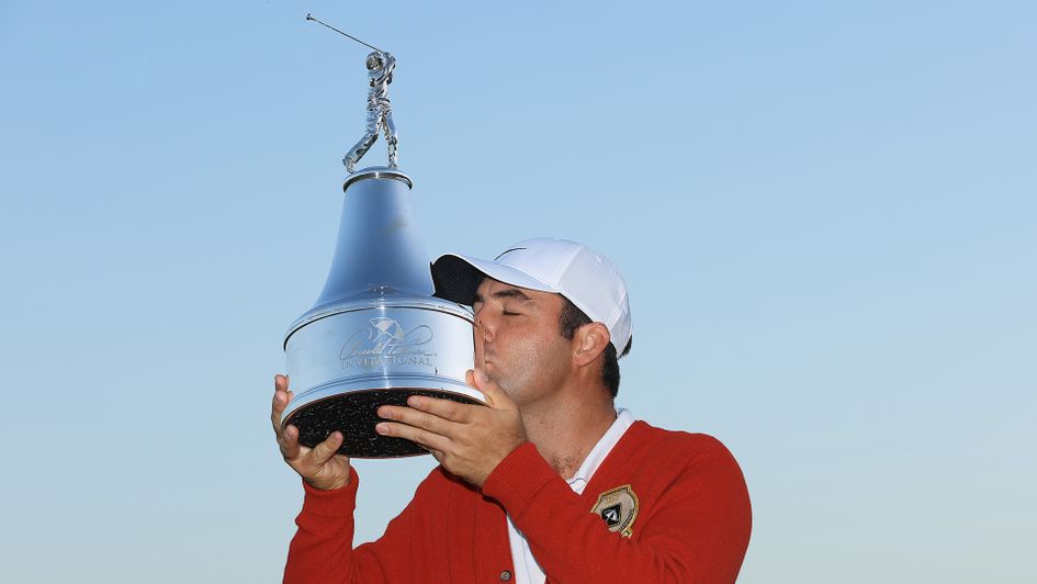 Scottie Scheffler poses with the trophy after winning the Arnold Palmer Invitational