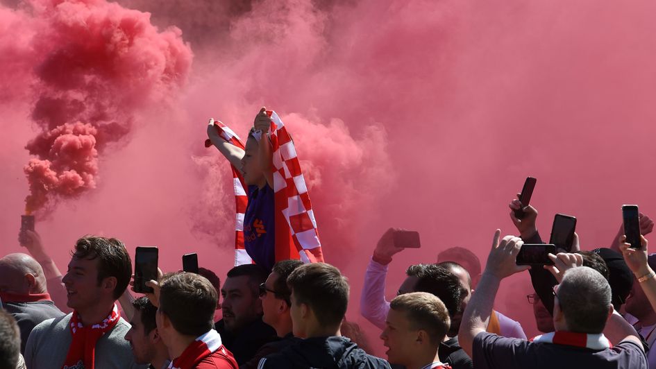 Liverpool fans welcome their team bus to Anfield ahead of their Premier League showdown with Wolves