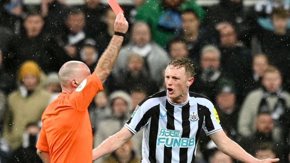 Newcastle's Sean Longstaff is shown a card