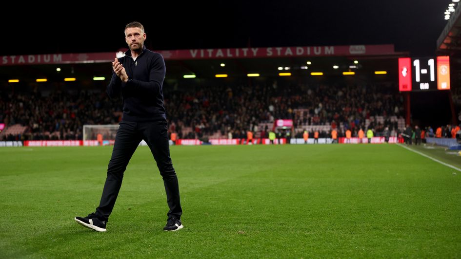 Luton Town manager Rob Edwards applauds the fans