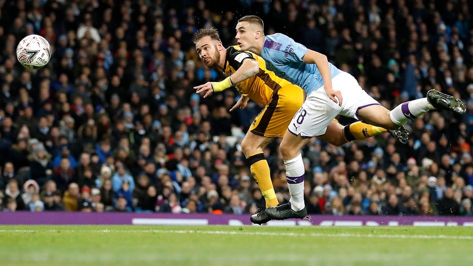 Port Vale's Tom Pope (centre) scores