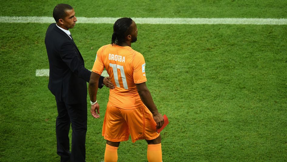 Sabri Lamouchi with Didier Drogba during Ivory Coast's win over Japan at the 2014 World Cup