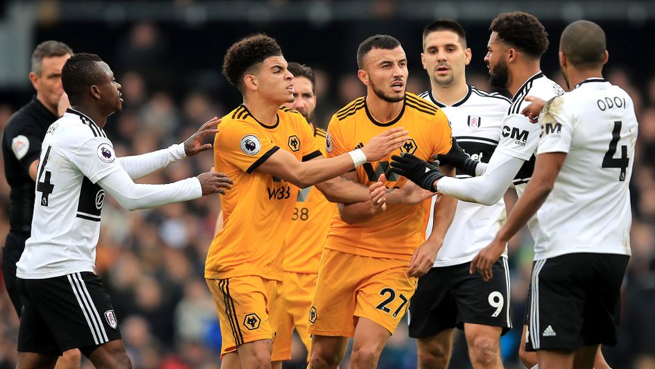 Wolves' Morgan Gibbs-White and Romain Saiss clash with Fulham's Cyrus Christie