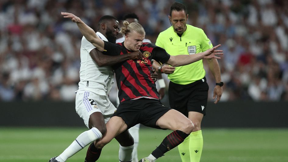 Antonio Rudiger grapples with Erling Haaland in the first leg