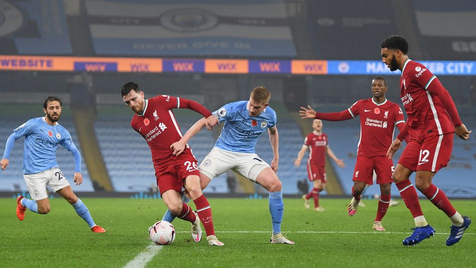 Andy Robertson is challenged by Kevin De Bruyne