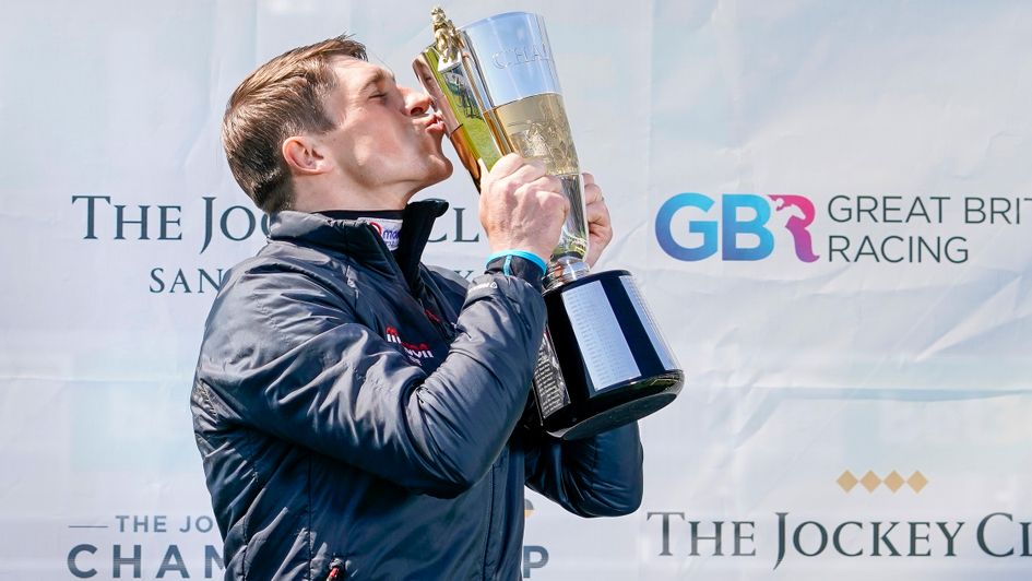 Harry Skelton kisses the champion jockey trophy