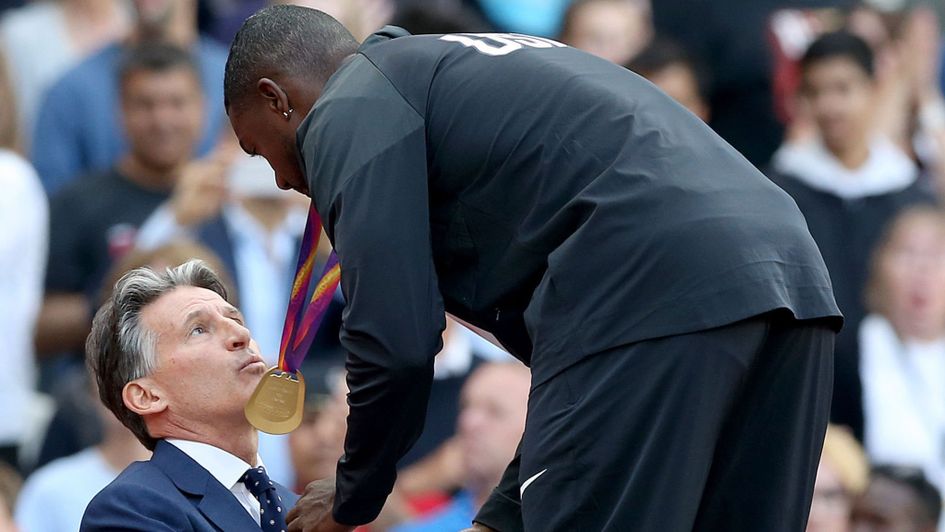 Justin Gatlin receives his gold medal from Lord Coe