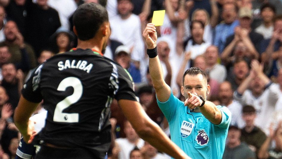 William Saliba is shown a card