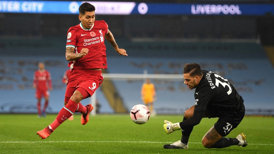 Liverpool's Roberto Firmino and Man City keeper Ederson battle for the ball